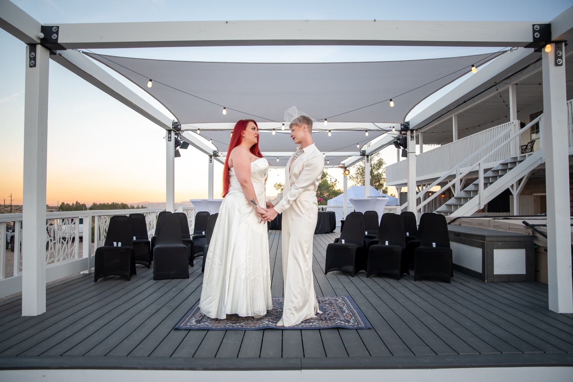 Sunset ceremony setup with staircase, white canopy structure, and mountain view